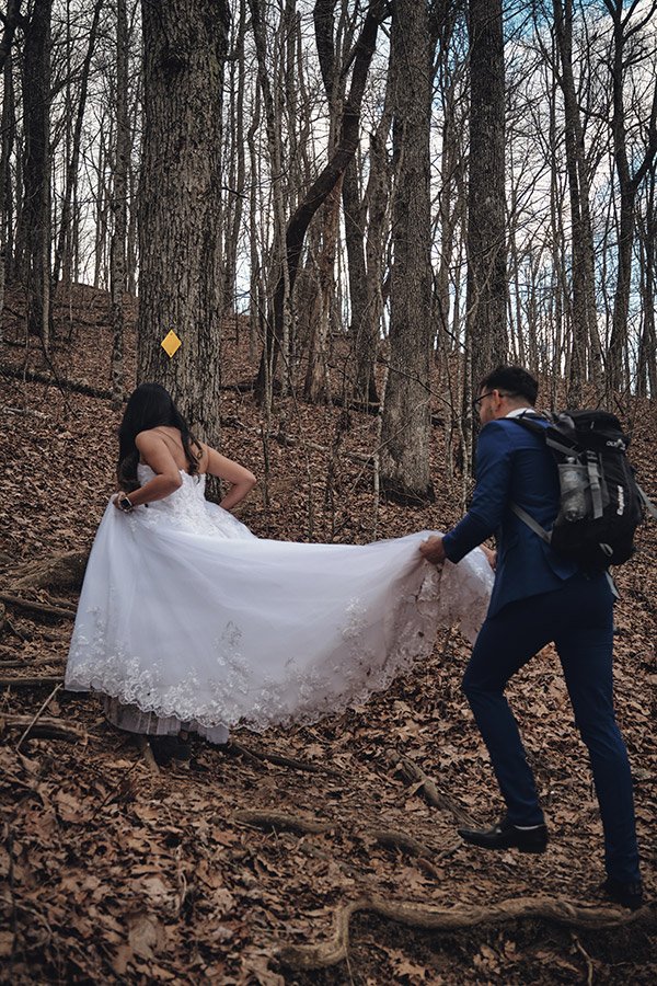 Bride and Groom hiking up mountain