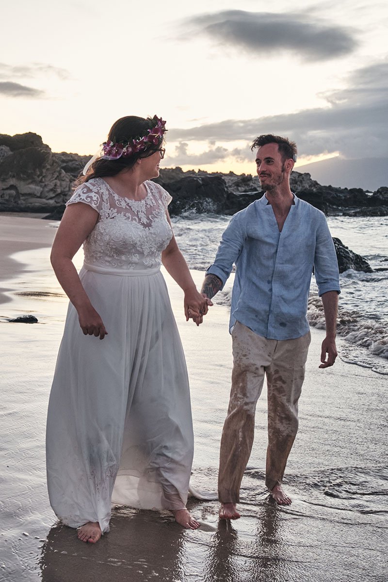 Couple plays in the water during their elopement