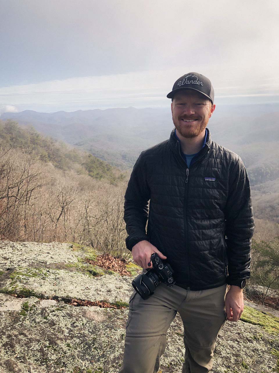 Acadia National Park elopement photographer stands with his camera in hand