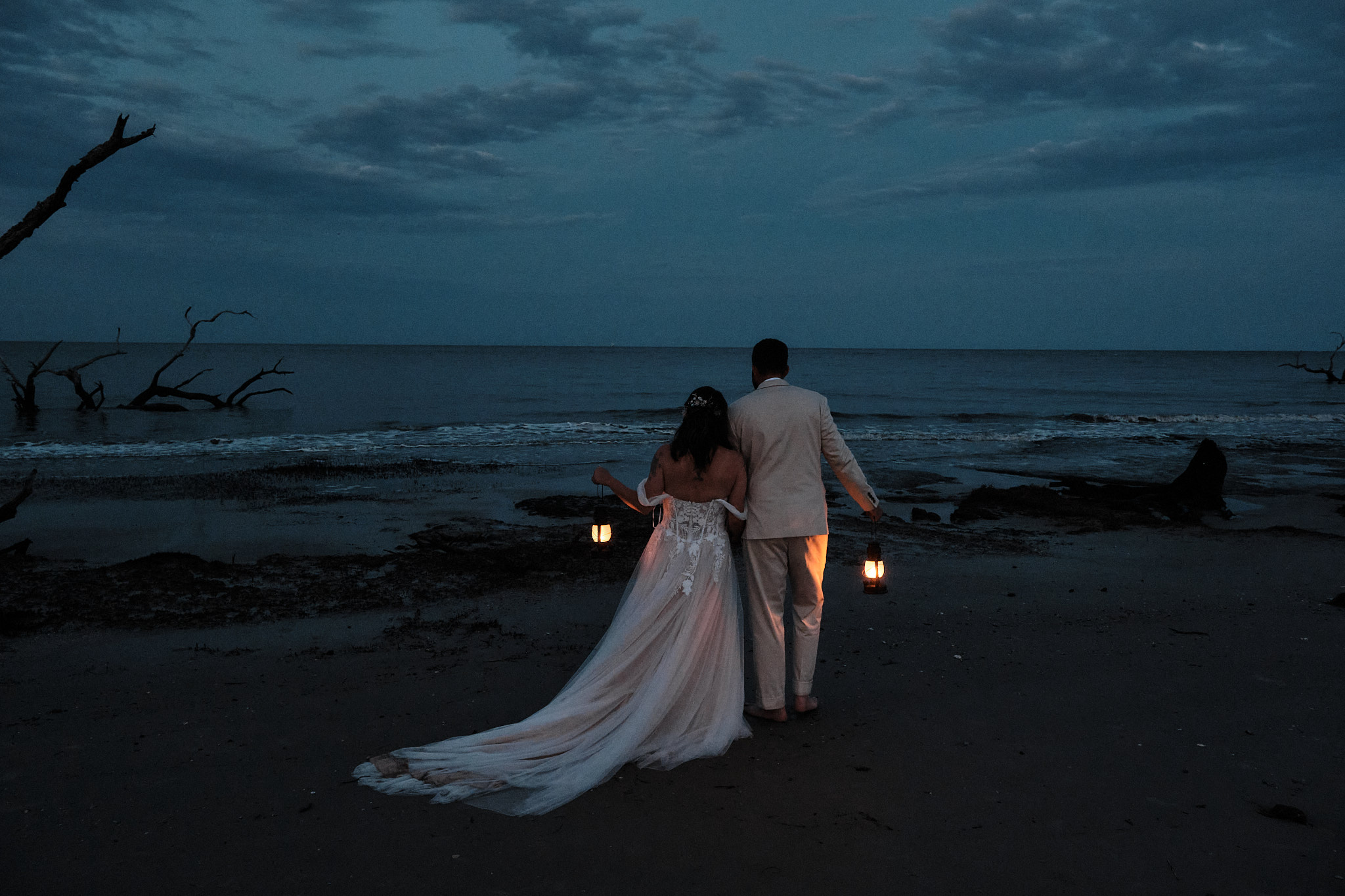 Couple holding lanterns at blue hour on their elopement day