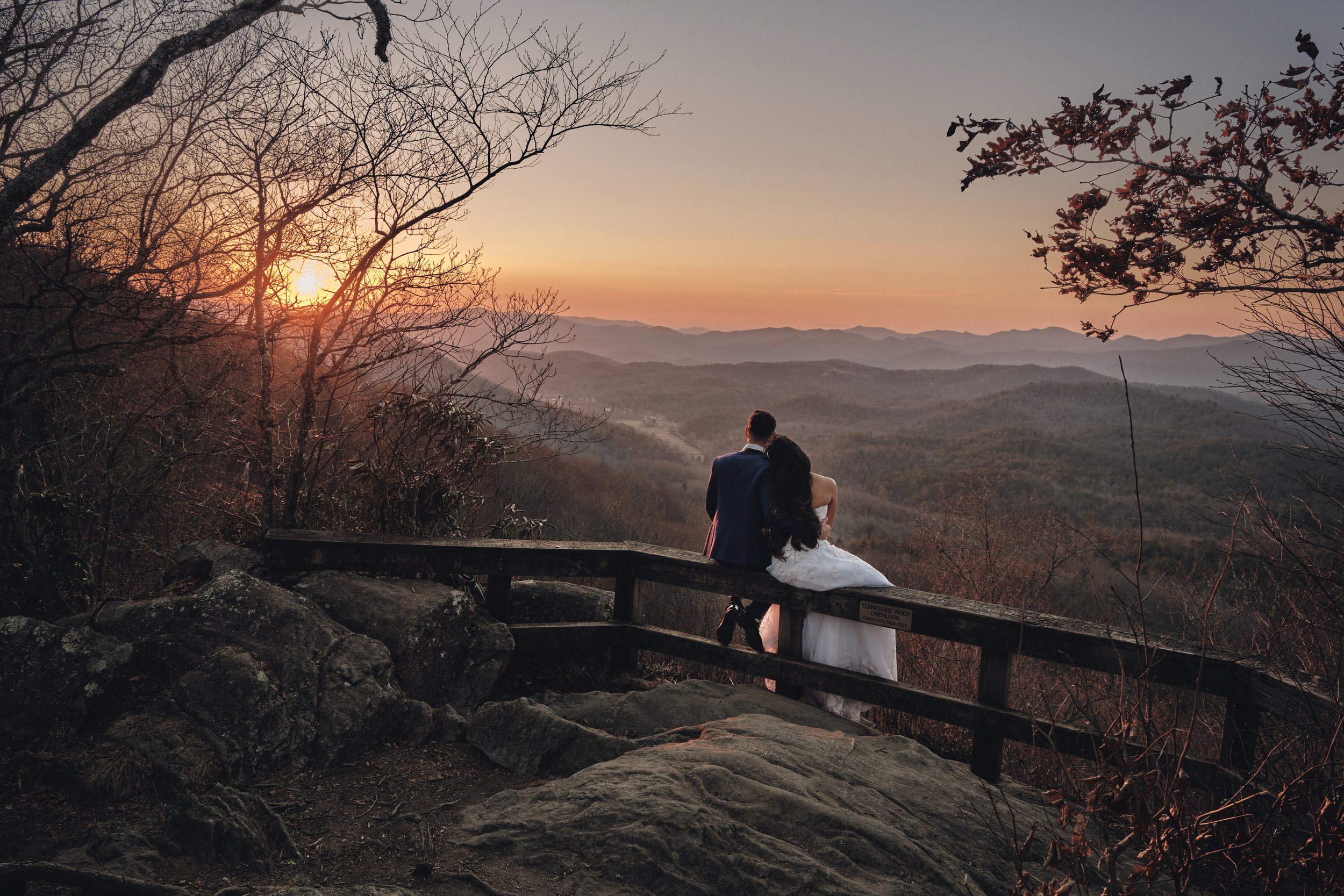 Eloping couple watches the sunset in the North Georgia Mountains