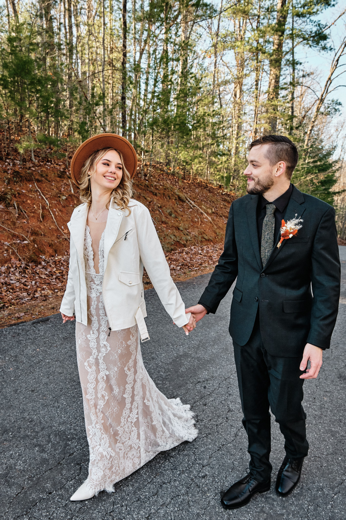 Eloping couple smiling and walking together.