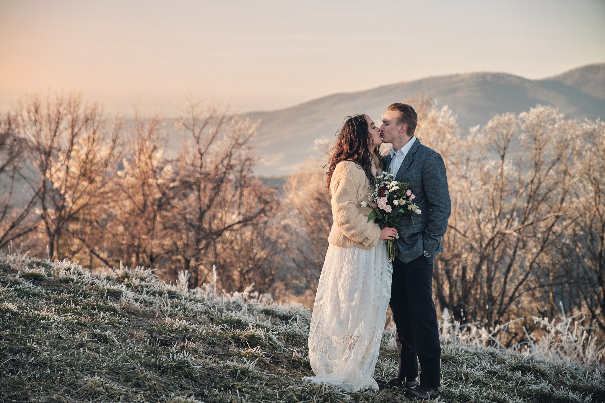 A couple eloping in the snowy mountains.