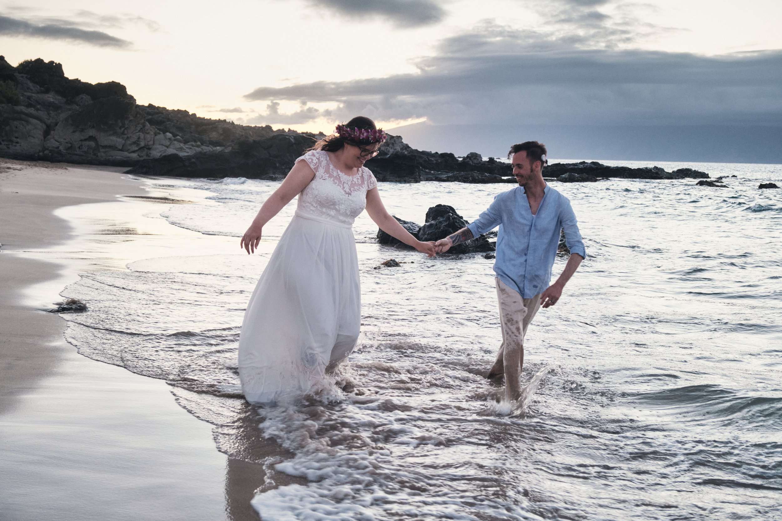 Couple splashing the waves of Hawaii