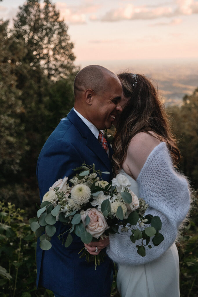 Laughing eloping couple at sunset