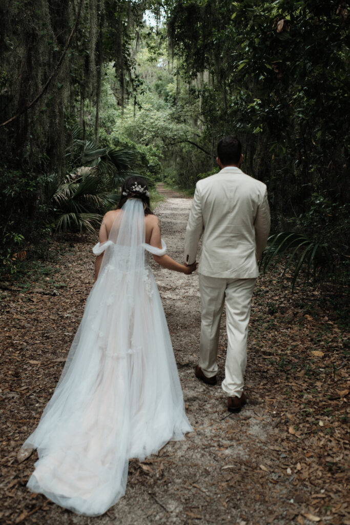 Eloping couple walking through a secluded forest