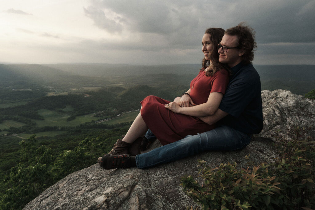 Couple sitting with each other watching the sunset down in the Tennessee valley.