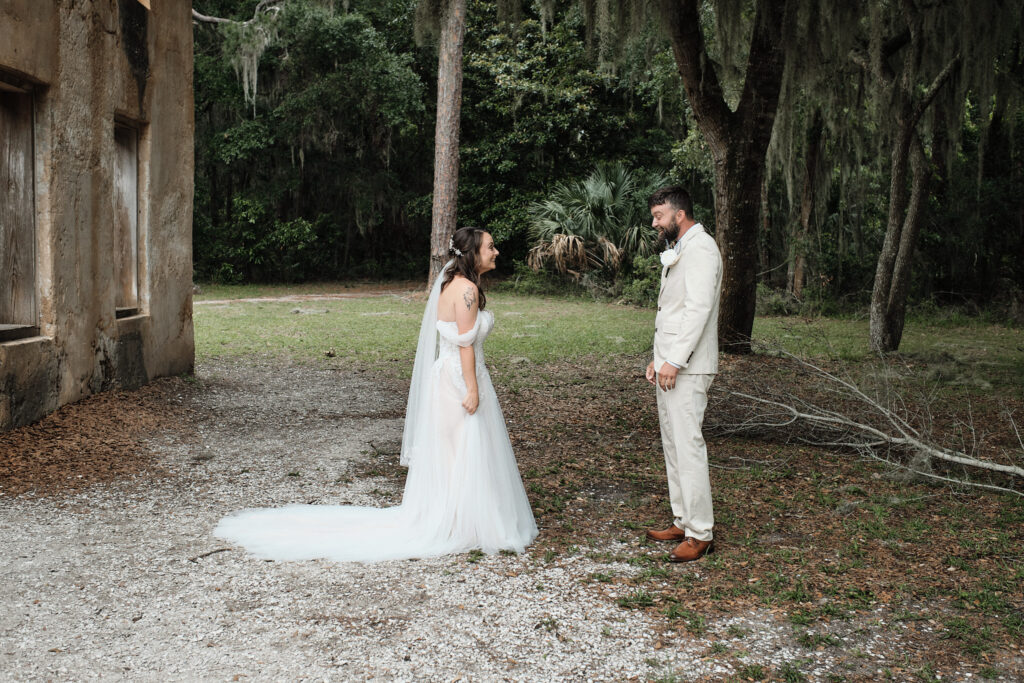 Jekyll Island Wedding couple looks at each other in their wedding attire for the first time