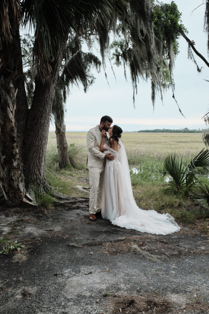 Couple kissing overlooking the intercoastal waters of Jekyll Island