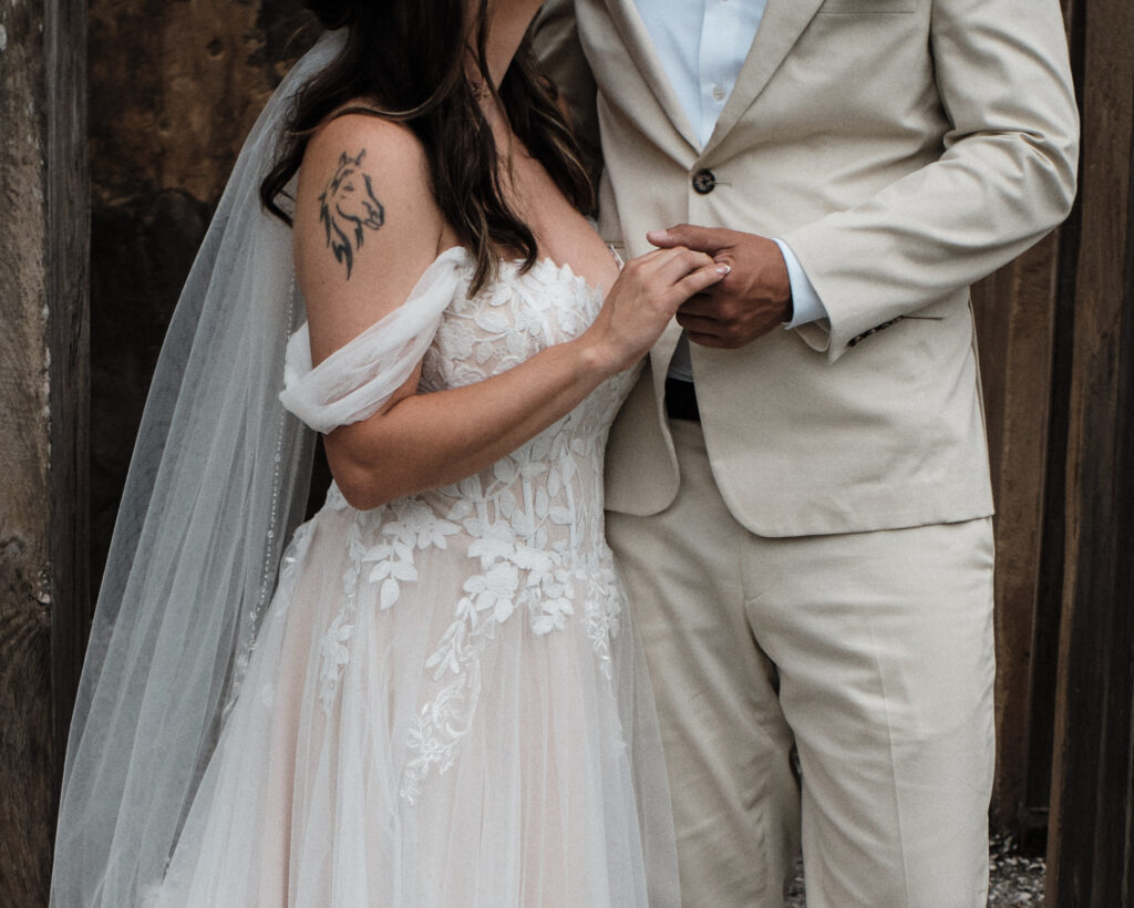 Couple holding hands on their wedding day