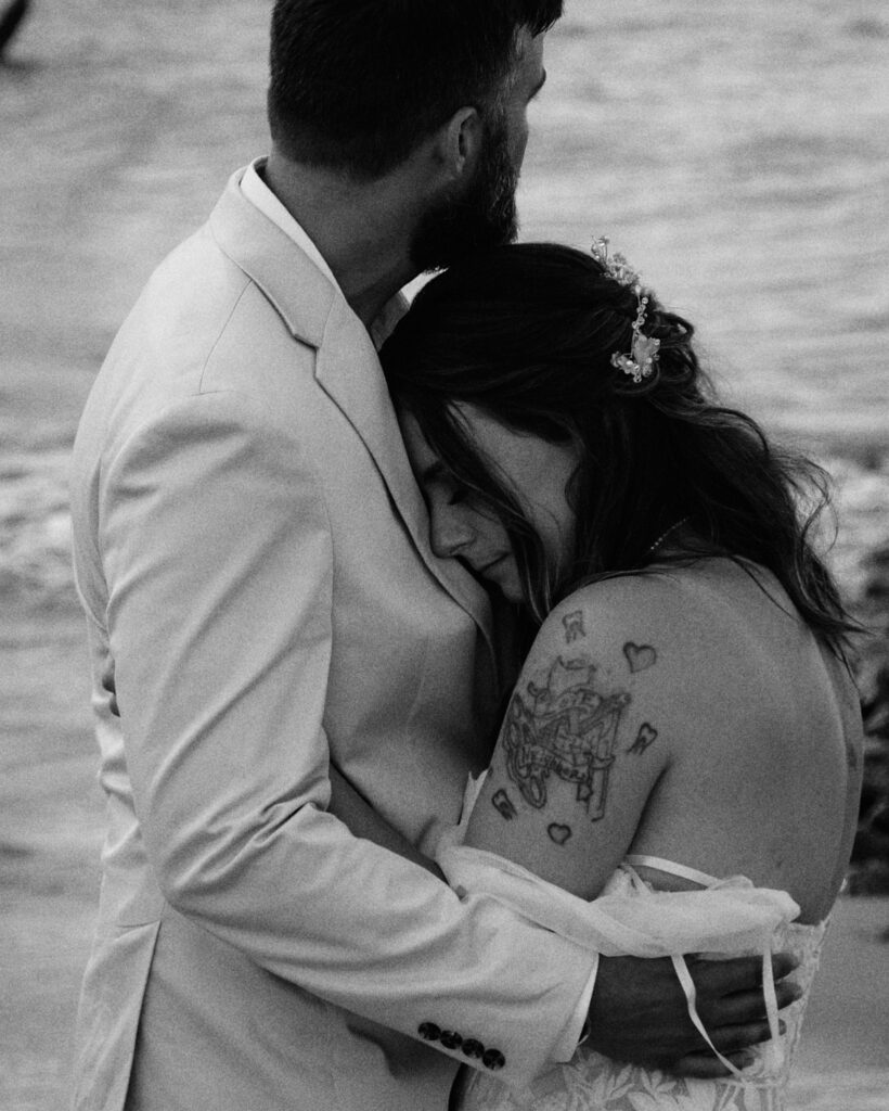 Eloping couple holding each other close during their first dance