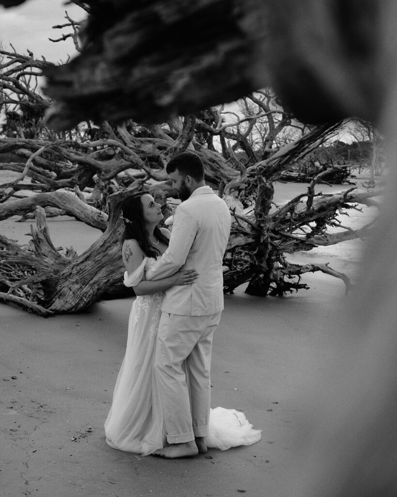 Eloping couple sharing first dance on the beach