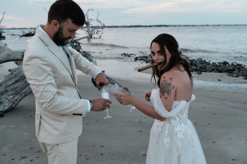 Eloping couple celebrating their wedding with champagne and cigar