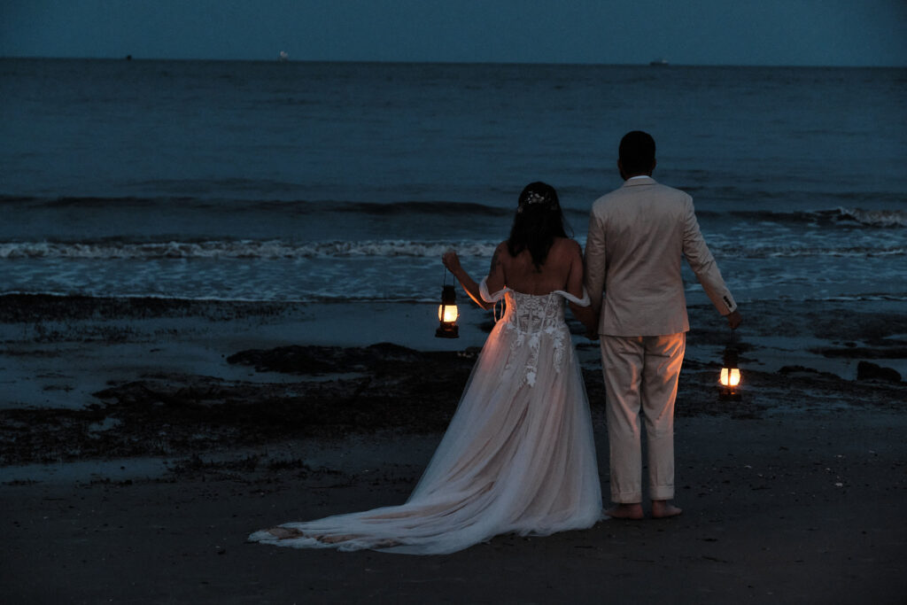 Wedding couple staring out into the ocean during blue hour 