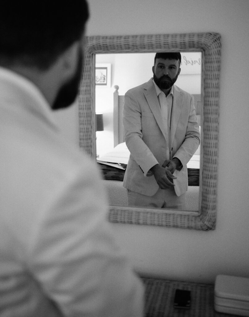 Groom getting ready in the mirror before a Jekyll Island Elopement