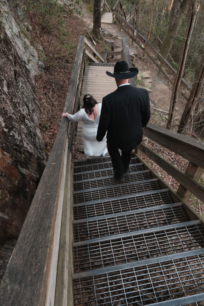 Eloping couple hikes down stairs in Cloudland Canyon