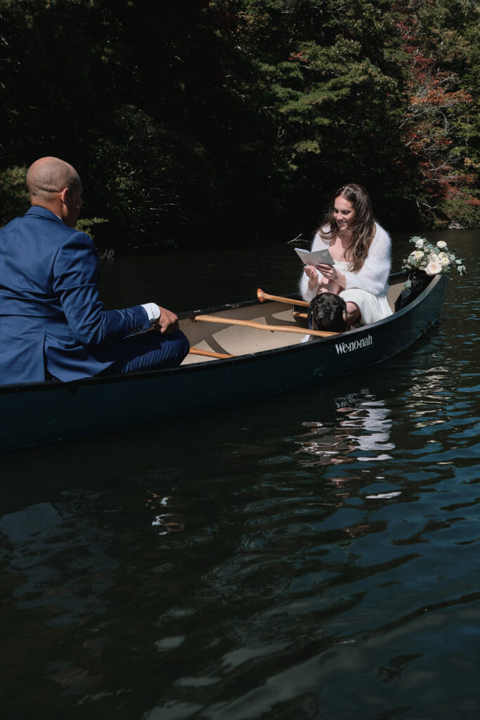 Eloping couple shares their vows in a canoe.