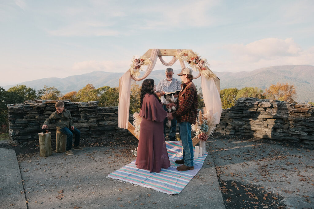 Unique elopement overlooking the mountains with non-traditional wedding attire