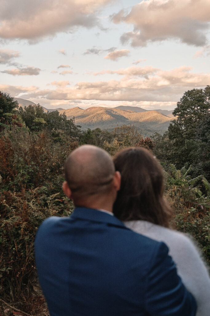 Eloping couple looks out at the mountains on their wedding day