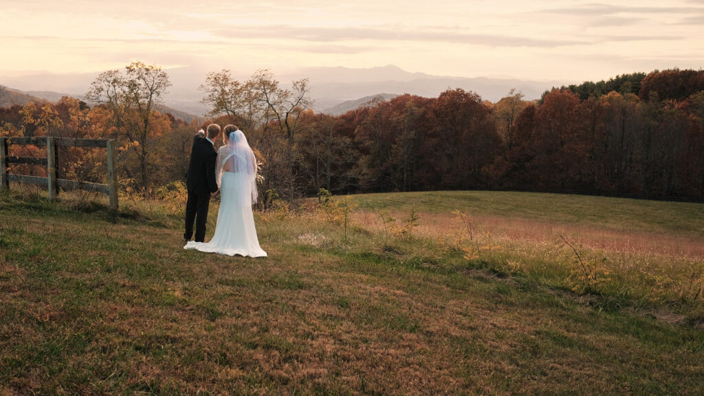 Eloping couple points at the mountains in their unique elopement location.