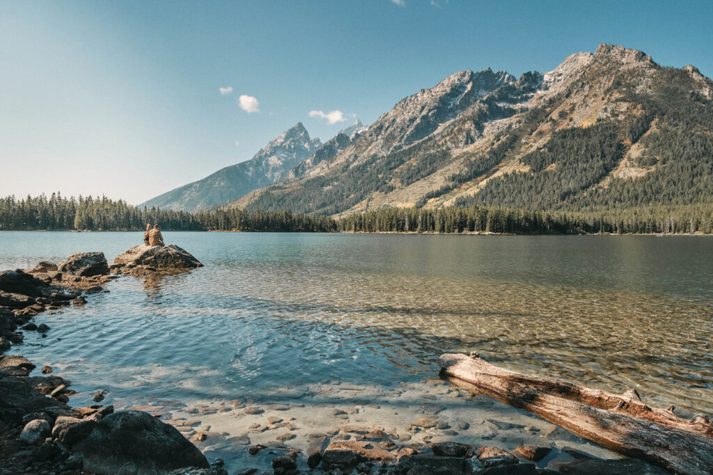 Couple sits among the Grand Tetons