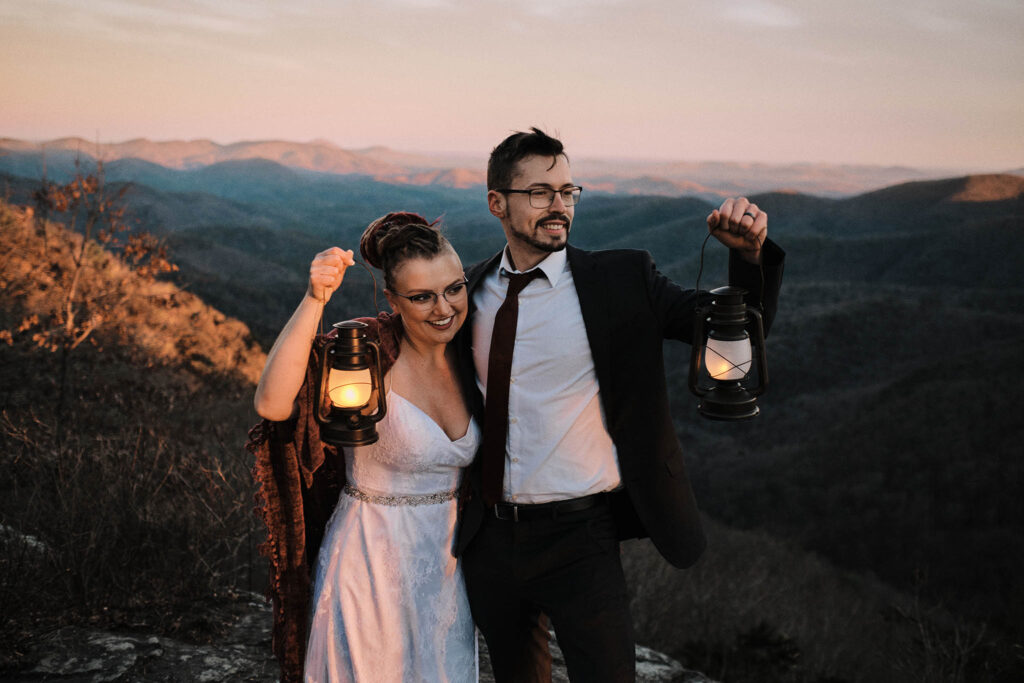 Eloping couple with lanterns looking out into the distance