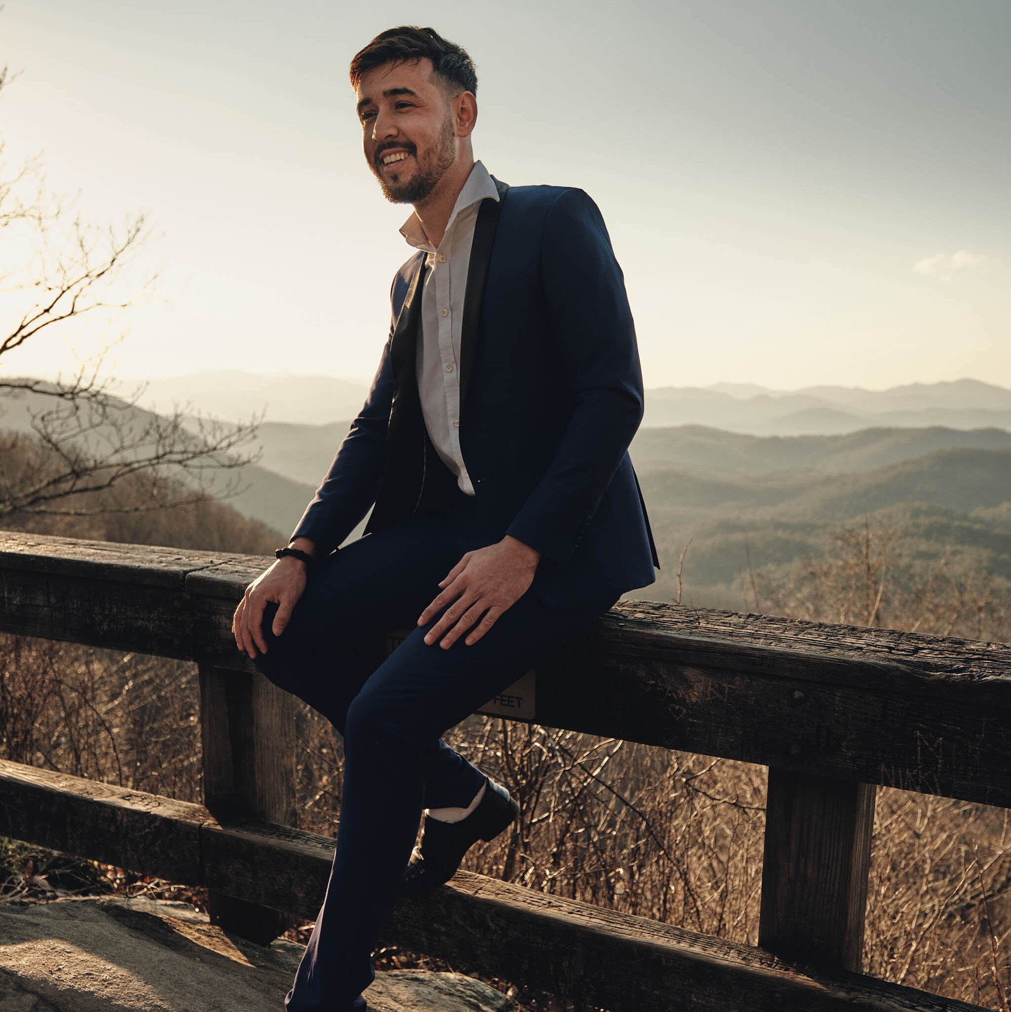 Hiking groom in his suit