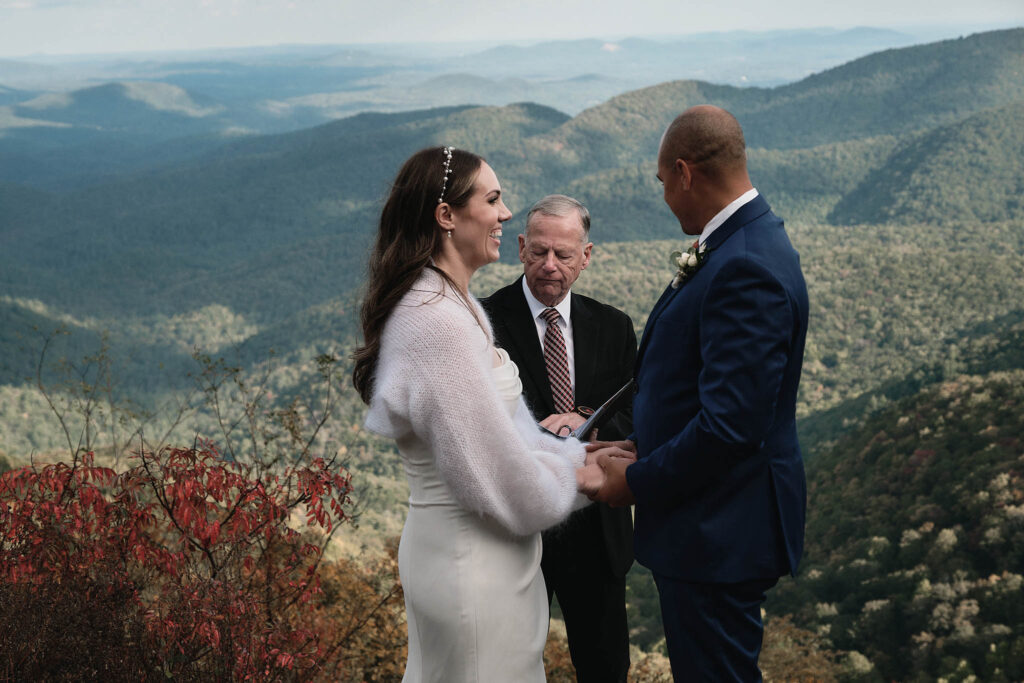 Hiking elopement ceremony as a couple holds hands