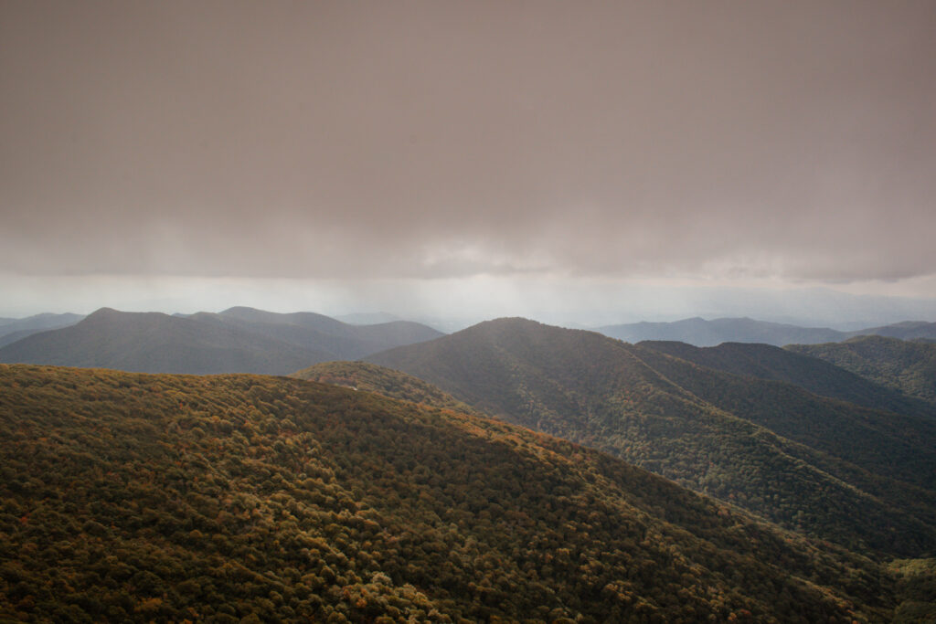 Mountain view with sun rays bursting through the clouds