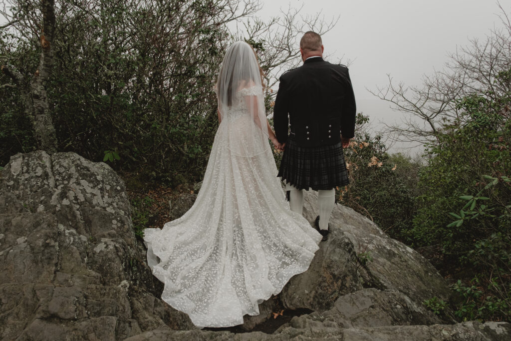 Eloping couple stares out into the fog