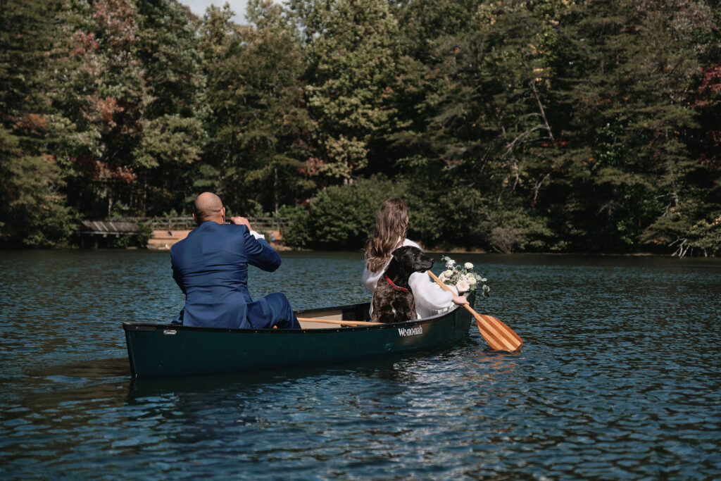 Eloping couple paddles out in a canoe