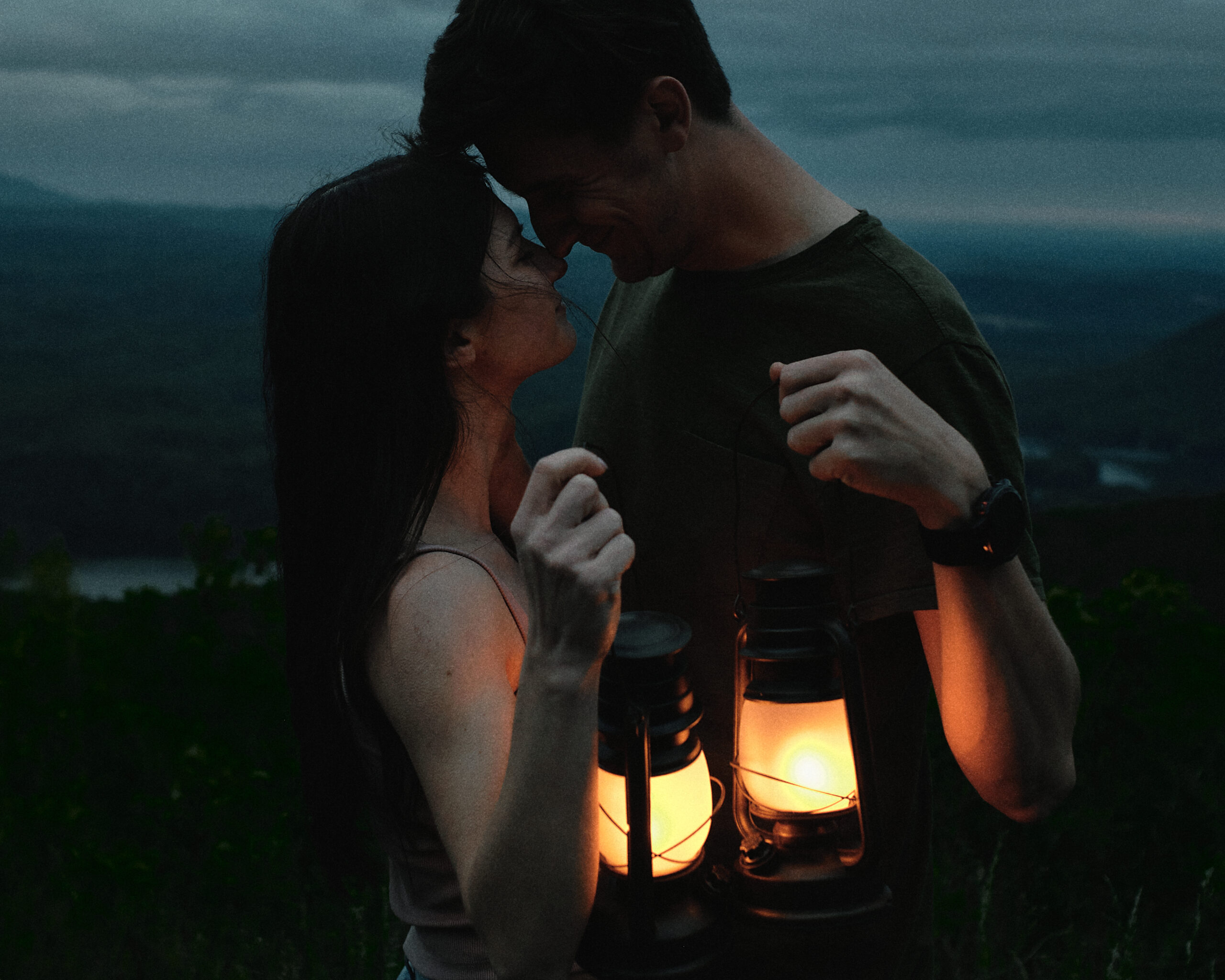 Couple sharing an intimate moment with lanterns at blue hour