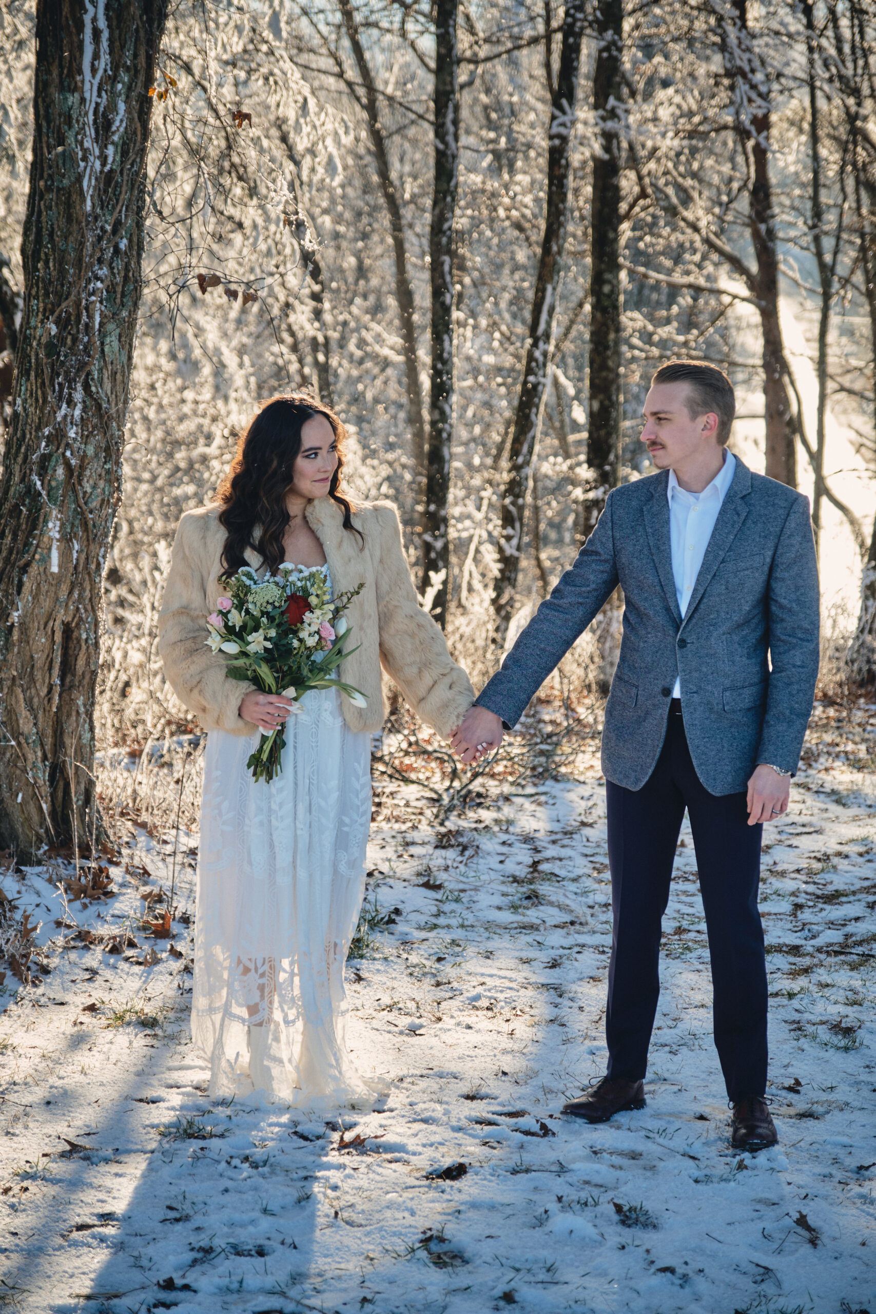 Couple looks at each other during their winter elopement in Acadia National Park